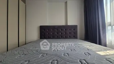 Spacious bedroom with elegant headboard and ample natural light