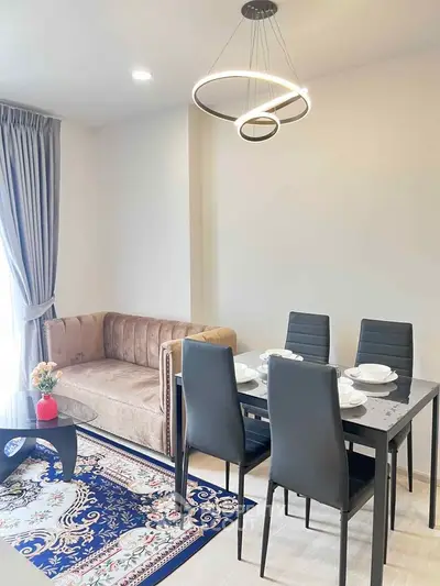 Modern living room with elegant dining area and stylish lighting