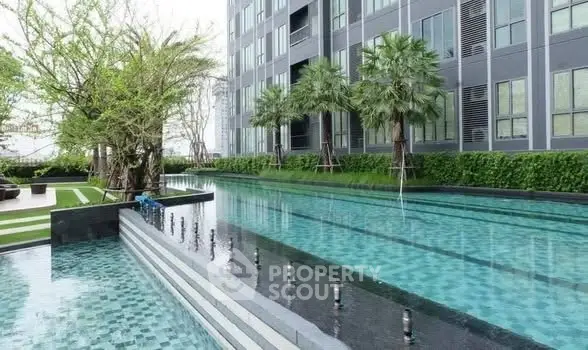 Luxurious condominium with stunning outdoor pool and lush greenery, perfect for relaxation and leisure.