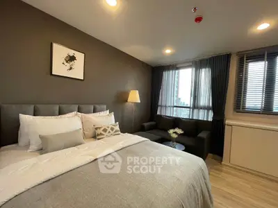 Luxurious bedroom with modern decor and city view, featuring cozy bed and stylish furnishings.