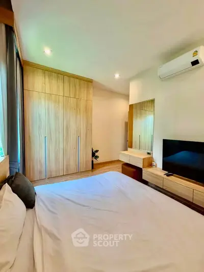 Modern bedroom with wooden wardrobe and sleek furniture design