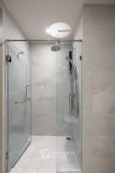 Modern bathroom with glass shower enclosure and sleek fixtures