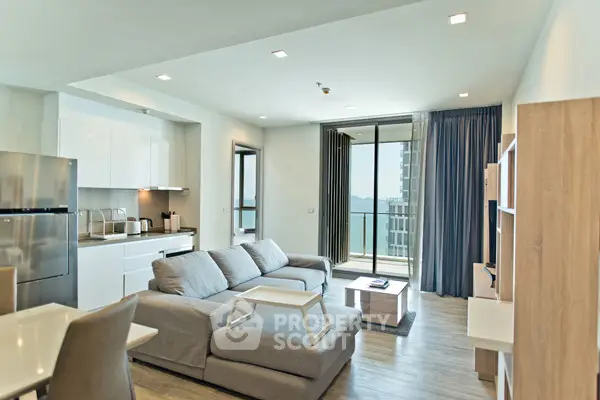 Modern open-plan living room with kitchen and stunning sea view balcony