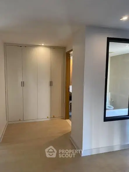 Modern apartment interior with built-in wardrobe and bathroom view