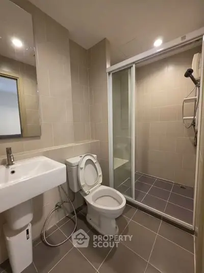 Modern bathroom with sleek shower and elegant fixtures in a contemporary apartment.