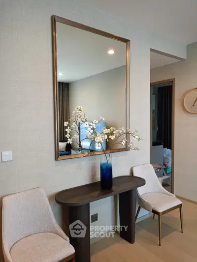 Elegant interior with modern decor, featuring a stylish console table and mirror, perfect for contemporary living.