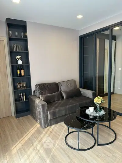 Modern living room with sleek black furniture and built-in shelving
