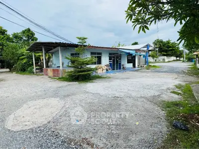 Charming rural property with spacious outdoor area and lush greenery, perfect for serene living.