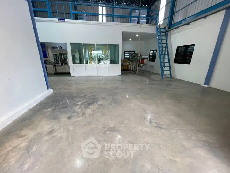 Spacious industrial warehouse with mezzanine and polished concrete floors.