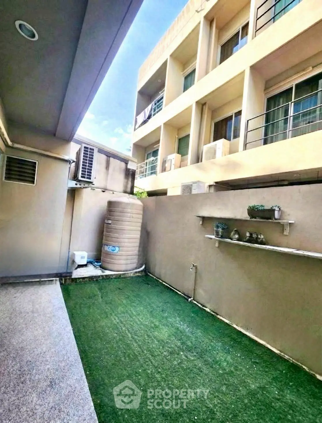 Modern apartment exterior with artificial grass and sleek architecture