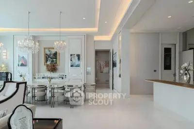 Luxurious open-plan living and dining area with elegant chandeliers and modern decor