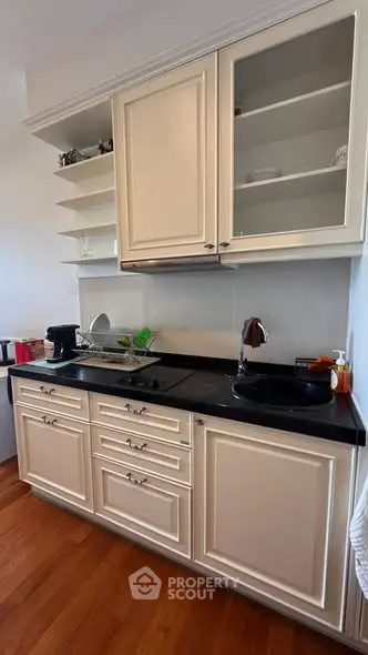 Charming kitchen with classic cabinetry and modern appliances, perfect for culinary enthusiasts.