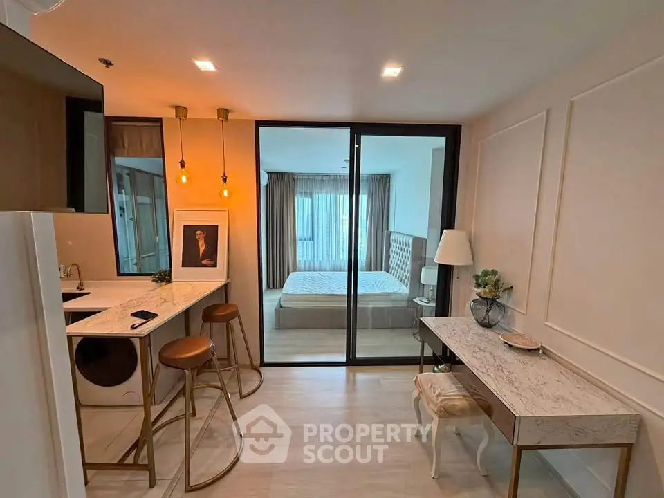 Modern studio apartment with stylish interior and glass partitioned bedroom
