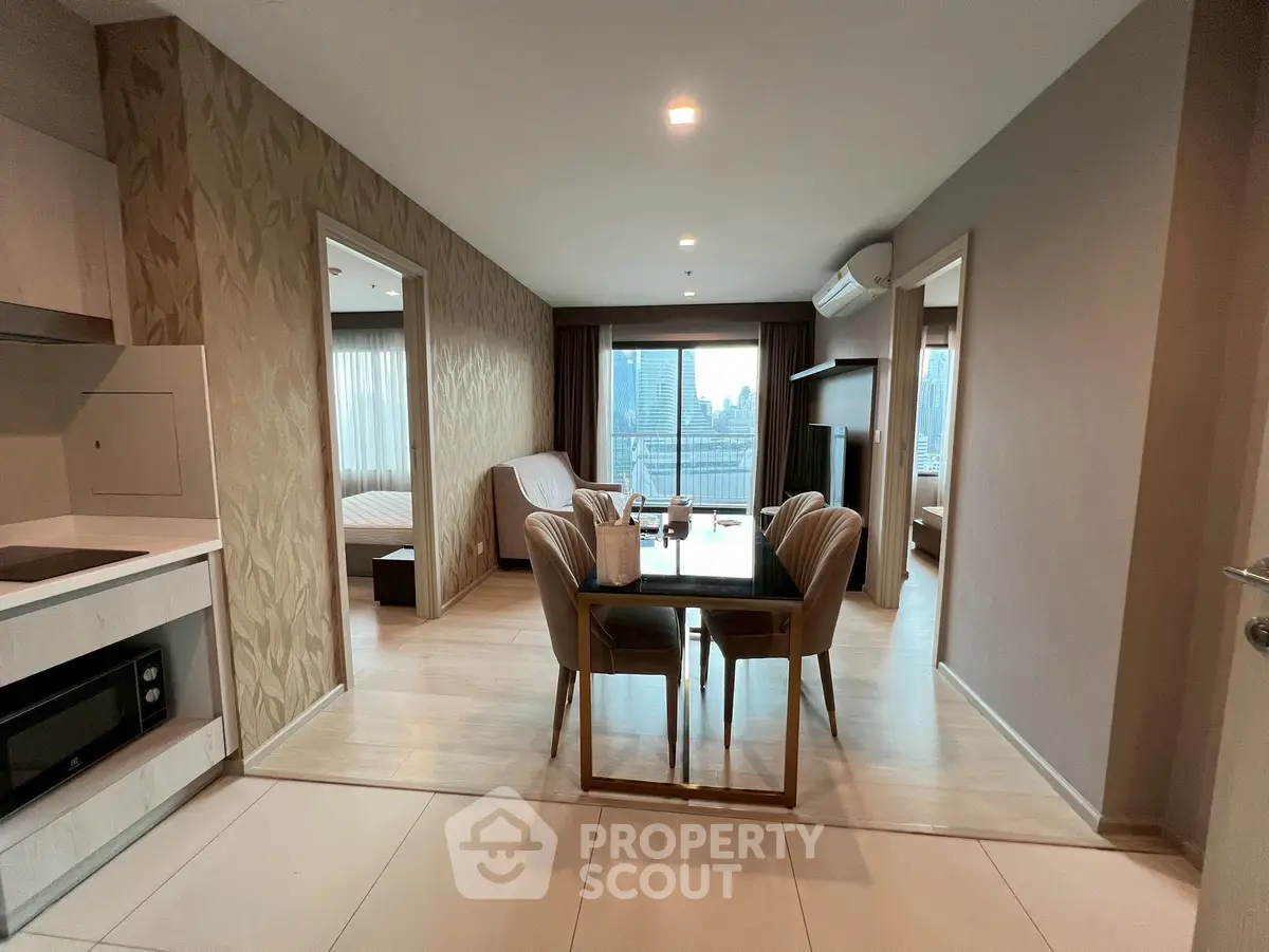 Modern open-plan living and dining area with city view in high-rise apartment