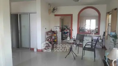 Spacious living area with modern furniture and ample natural light, perfect for relaxation and entertaining.
