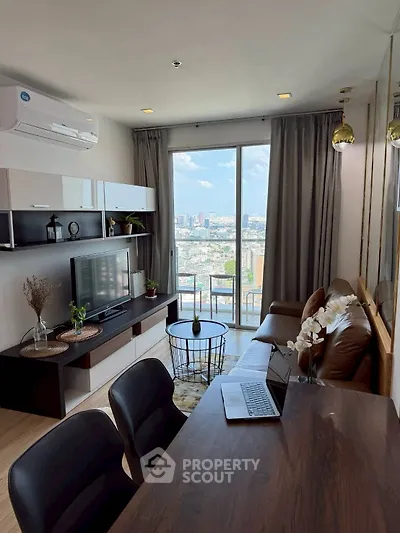 Modern living room with city view, stylish furniture, and natural light
