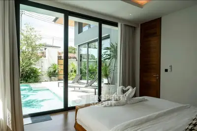 Luxurious bedroom with pool view and elegant decor in modern home