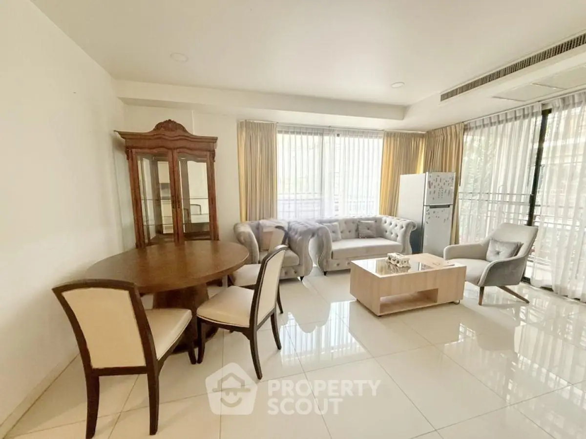 Spacious living room with elegant furniture and large windows for natural light.