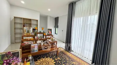Spacious living room with elegant decor and large windows for natural light.
