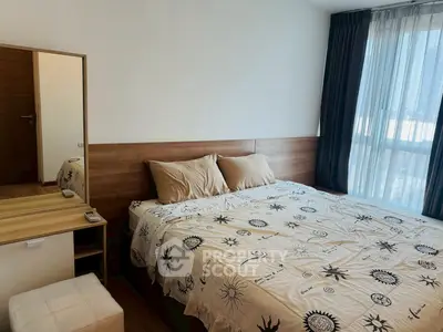 Cozy bedroom with stylish decor and large window for natural light