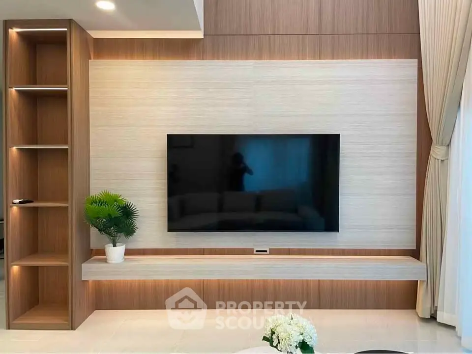 Modern living room with sleek TV setup and elegant wood paneling