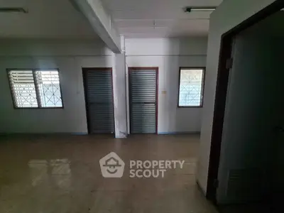 Spacious interior with tiled flooring and secure windows, ideal for versatile use.