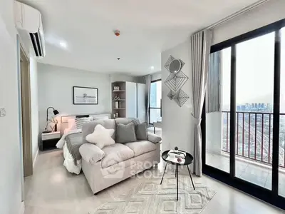 Modern bedroom with cozy seating and city view balcony in luxury apartment