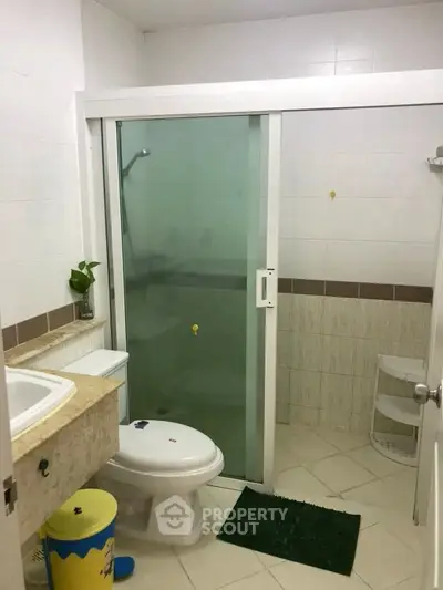 Modern bathroom with glass shower door and elegant tile design