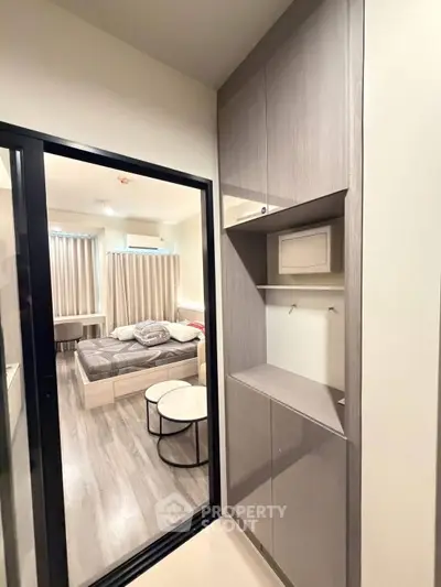 Modern bedroom with sliding glass door and built-in storage cabinets