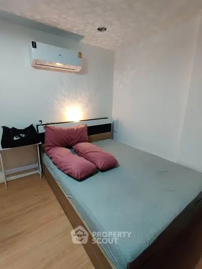 Cozy bedroom with modern air conditioning and stylish lighting, perfect for relaxation.