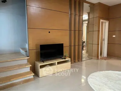 Modern living room with sleek wooden paneling and stylish TV setup