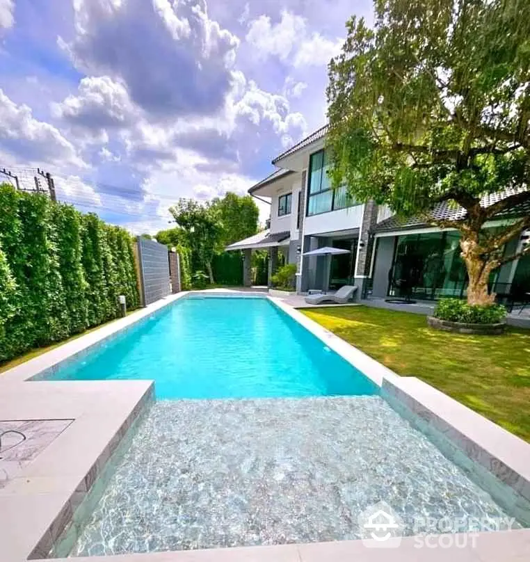 Luxurious modern home with stunning private pool and lush garden