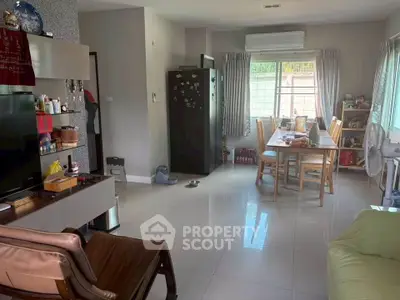 Spacious living room with modern decor and ample natural light, perfect for family gatherings.