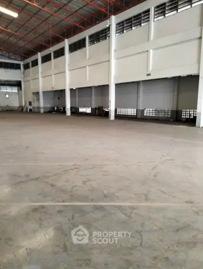 Spacious industrial warehouse with high ceilings and ample storage space.