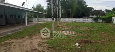 Spacious outdoor area with potential for development, featuring open land and surrounding greenery.