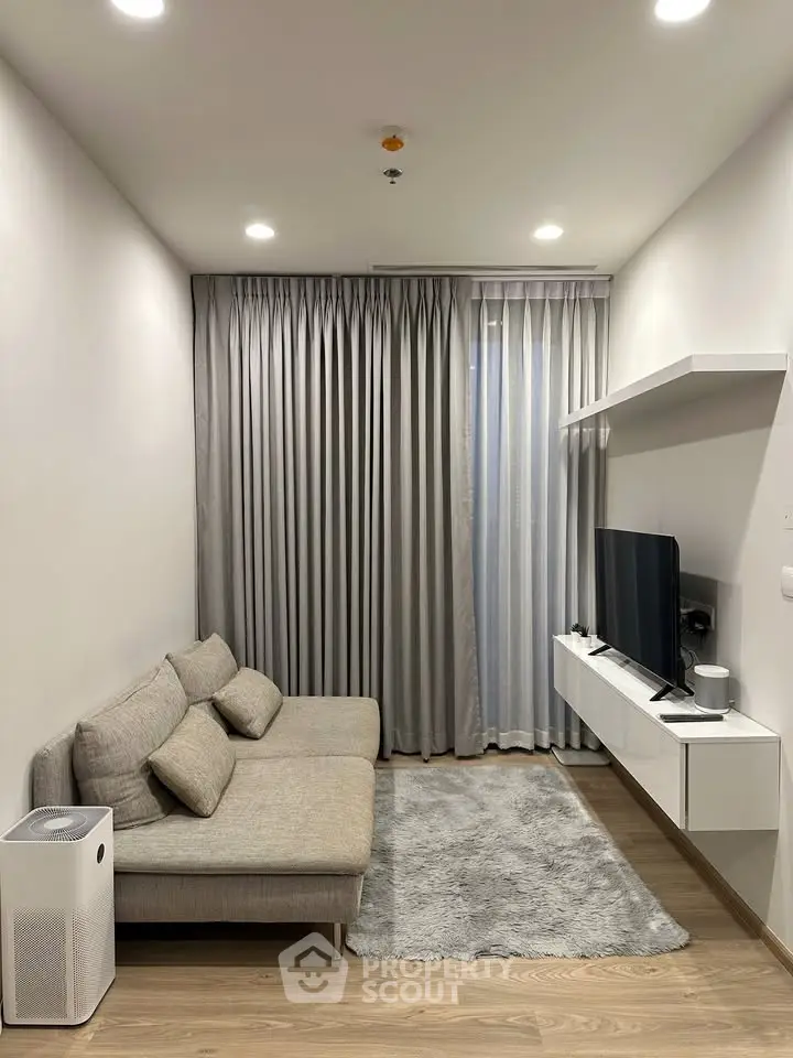 Modern living room with sleek furniture and floor-to-ceiling curtains