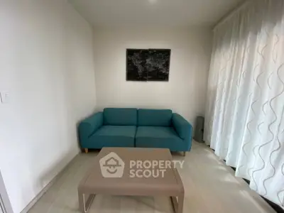 Modern living room with teal sofa and minimalist decor