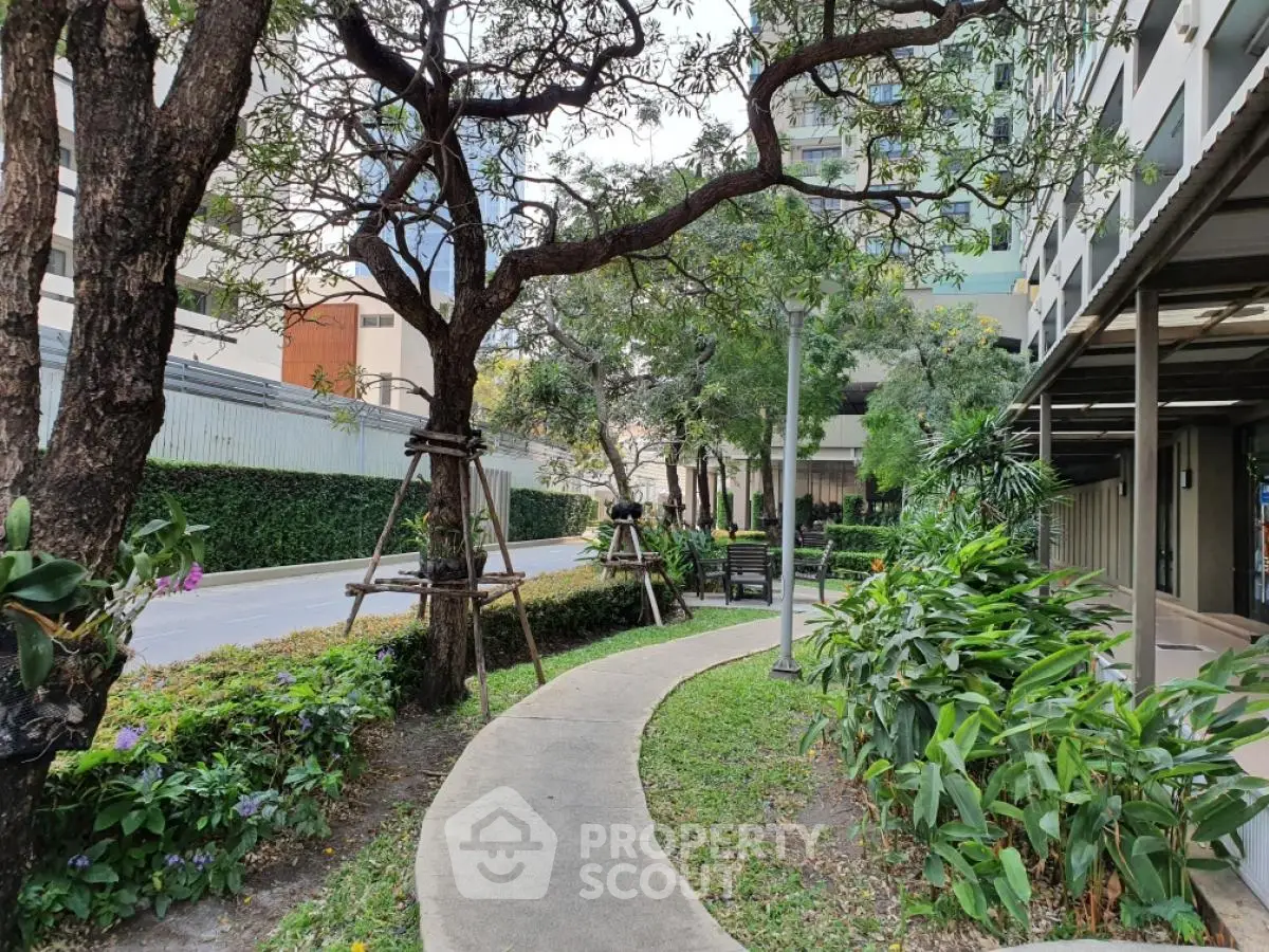Serene garden pathway with lush greenery in modern residential complex