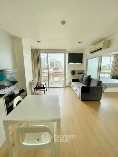 Modern open-plan living room with city view and stylish furnishings