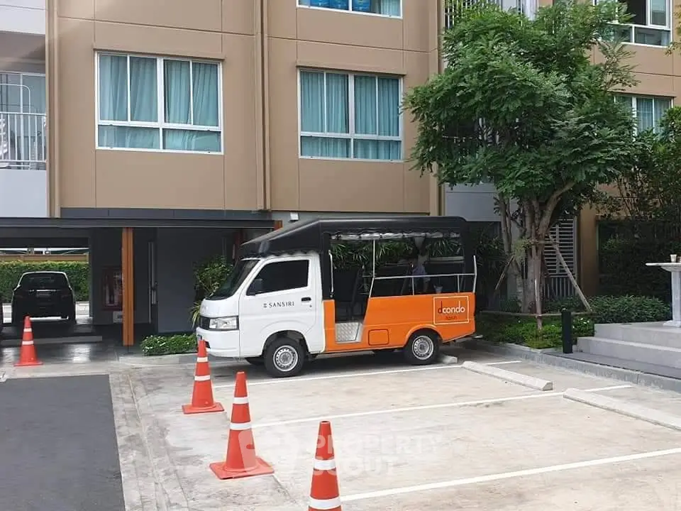 Modern condominium exterior with parking area and shuttle service