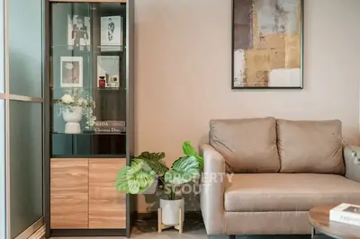 Modern living room with stylish sofa and glass cabinet