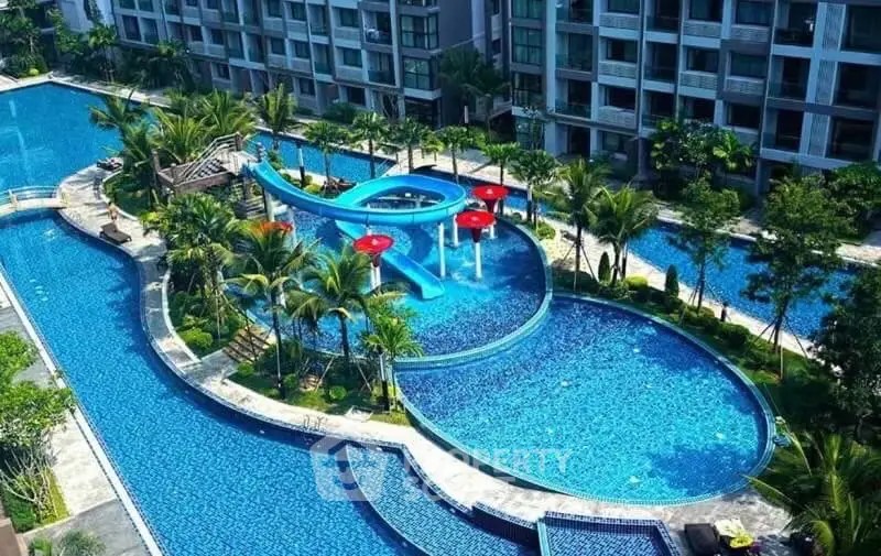 Luxurious residential complex with stunning pool and lush landscaping