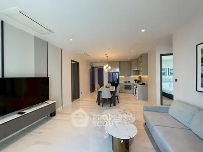 Modern open-plan living room with sleek kitchen and dining area, featuring elegant marble flooring.