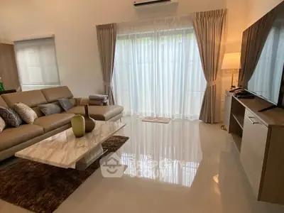 Elegant living room with modern furniture and large windows for natural light.