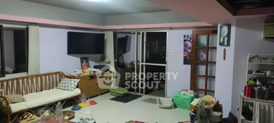 Spacious living room with modern decor and large windows for natural light.