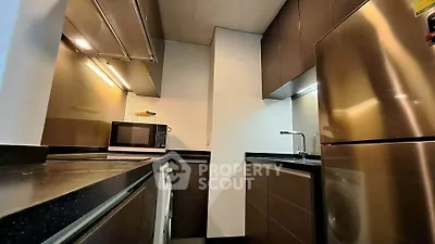 Modern kitchen with sleek cabinetry, stainless steel appliances, and efficient layout.
