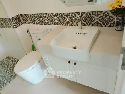 Modern bathroom with stylish tile design and sleek white fixtures
