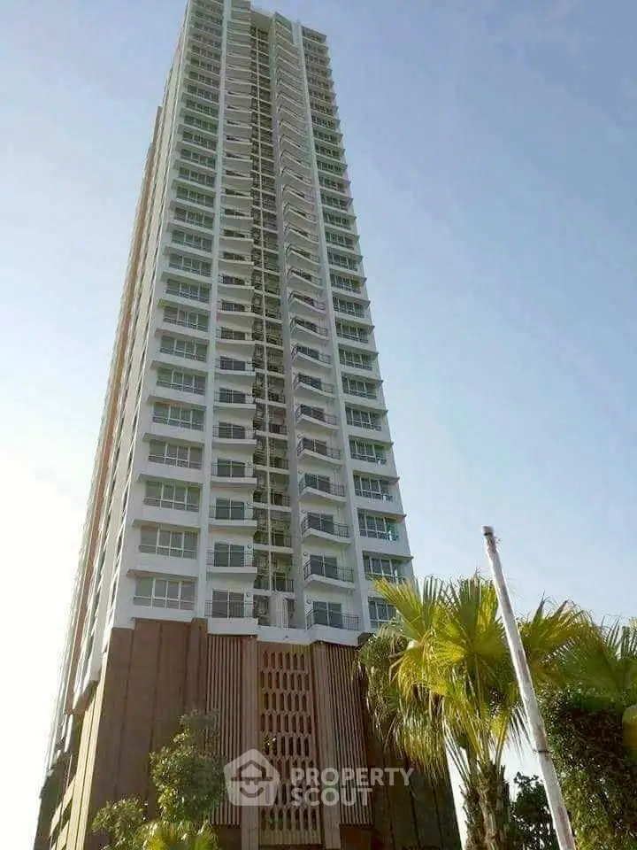 Stunning high-rise building with modern architecture and lush greenery.