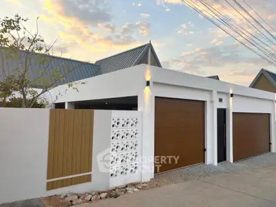 Modern minimalist house exterior with dual garage doors and sleek design.