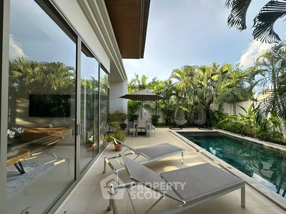 Luxurious tropical villa with private pool and lush garden, perfect for relaxation and entertaining.